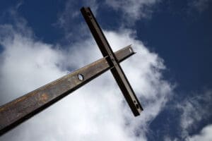 A picture of cross on a cloudy sky background. A cross that is reperesenitive of the cross that Jesus died on.
